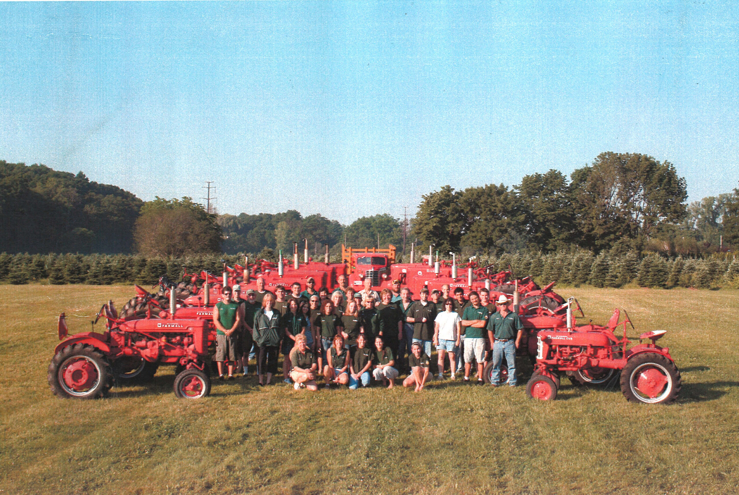 Group photo with red tractors.