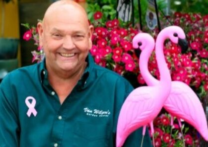 man with plastic flamingos