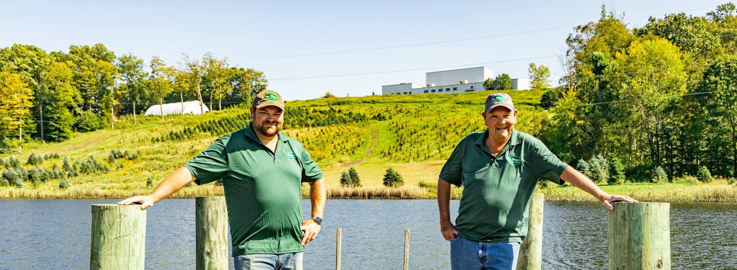 Van Wilgen's owners standing on a dock next to a pond.